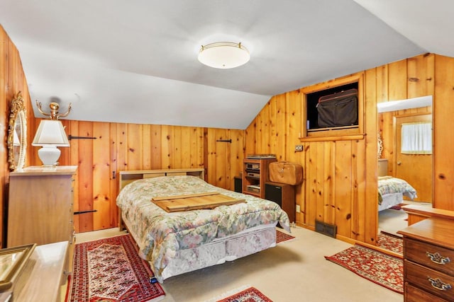 bedroom featuring visible vents, vaulted ceiling, wood walls, and carpet flooring