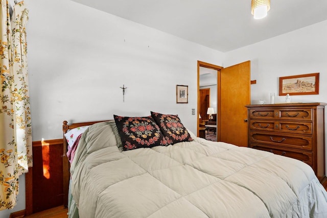 bedroom featuring baseboards and wood finished floors