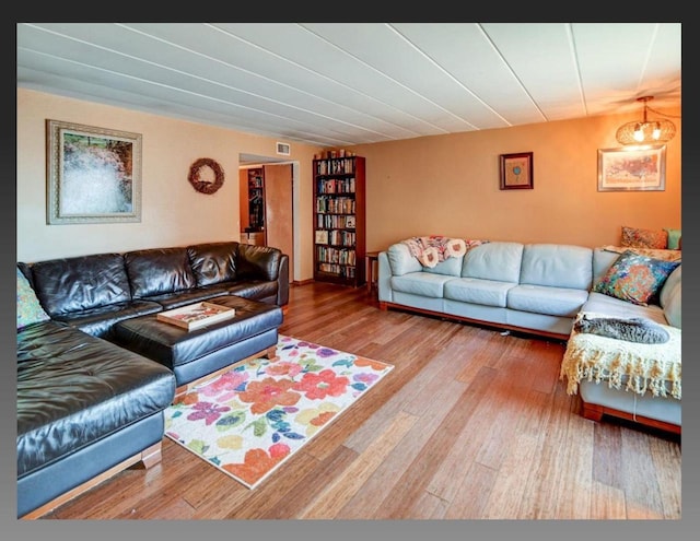 living area featuring hardwood / wood-style floors and visible vents