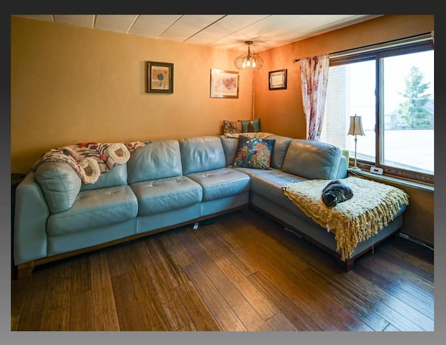 living area featuring a chandelier and hardwood / wood-style flooring