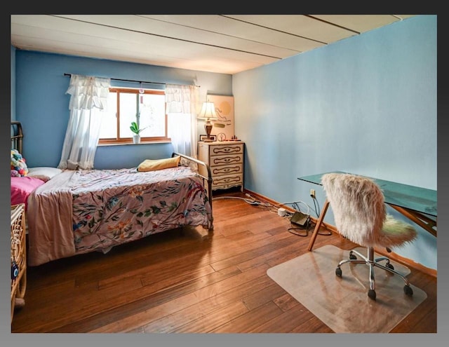 bedroom with hardwood / wood-style floors