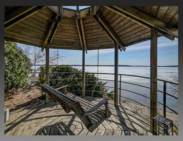 wooden deck featuring a water view