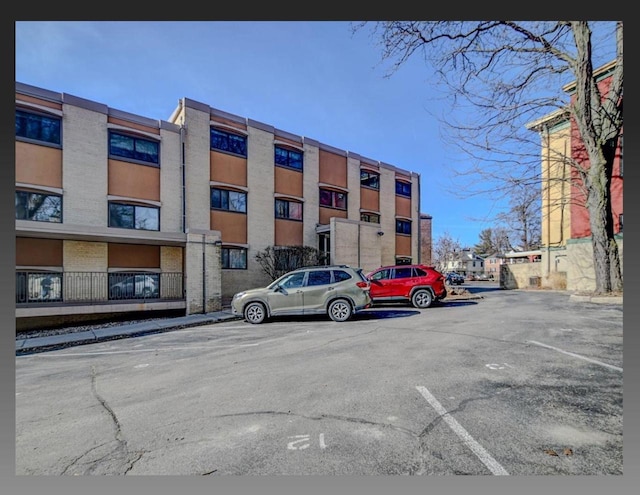 view of building exterior featuring uncovered parking