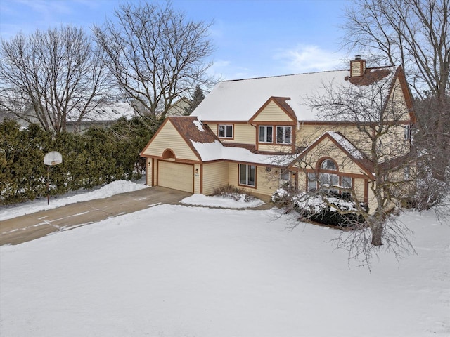 view of front of property with a garage, driveway, and a chimney