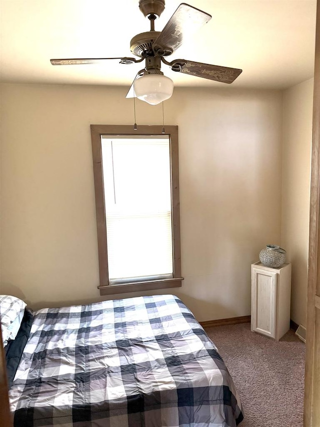 unfurnished bedroom featuring carpet flooring, ceiling fan, and baseboards