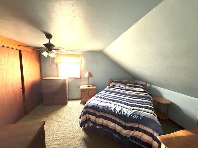 bedroom with vaulted ceiling, a ceiling fan, and light colored carpet