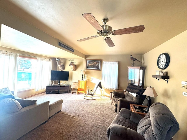 carpeted living area with plenty of natural light and ceiling fan