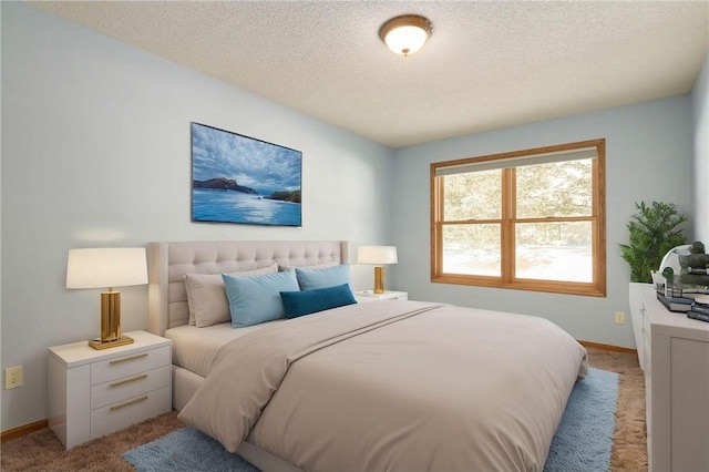 bedroom featuring baseboards, a textured ceiling, and light colored carpet