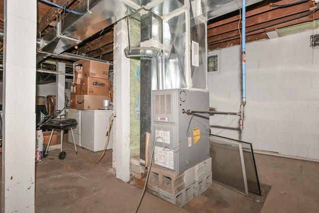 utility room featuring washer / dryer and heating unit