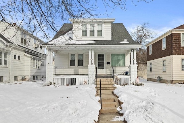 bungalow featuring a porch and a shingled roof