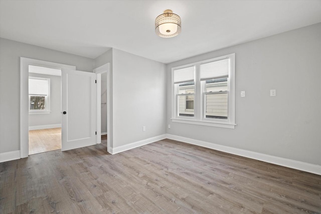 empty room with light wood-style floors and baseboards