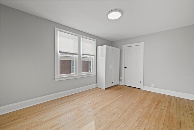 empty room featuring light wood-style flooring and baseboards