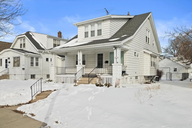 bungalow-style home with a shingled roof and a porch