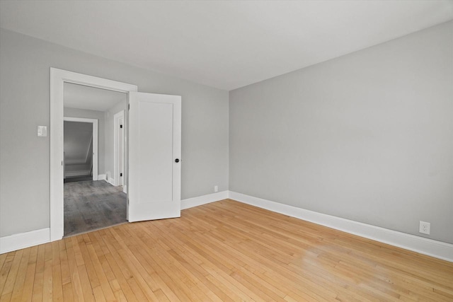 unfurnished room with light wood-style floors and baseboards