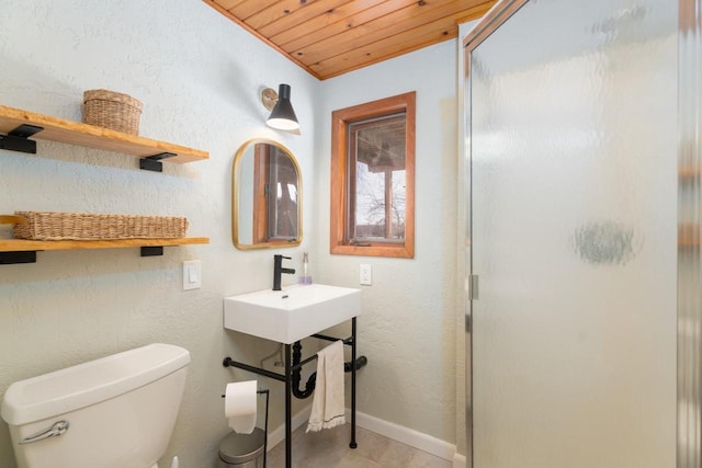 full bathroom with toilet, a stall shower, wood ceiling, and baseboards