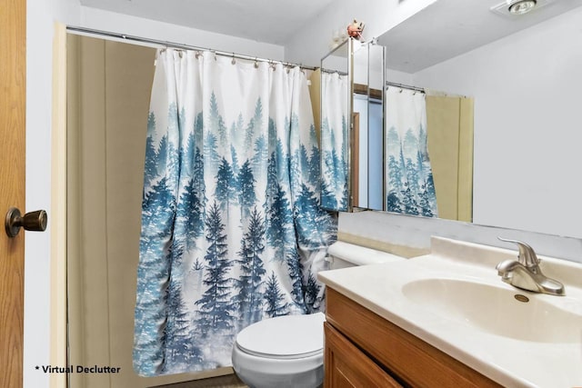 bathroom with toilet and vanity