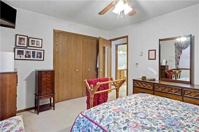 bedroom with ceiling fan, a closet, and light colored carpet