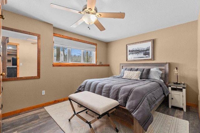 bedroom featuring a ceiling fan, dark wood-style flooring, and baseboards