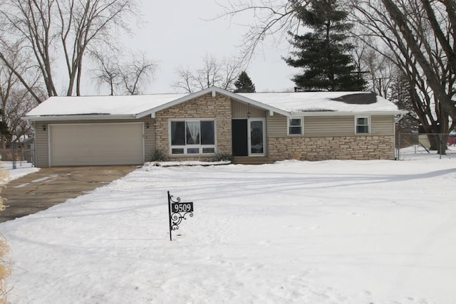 view of front of property with a garage, stone siding, and driveway