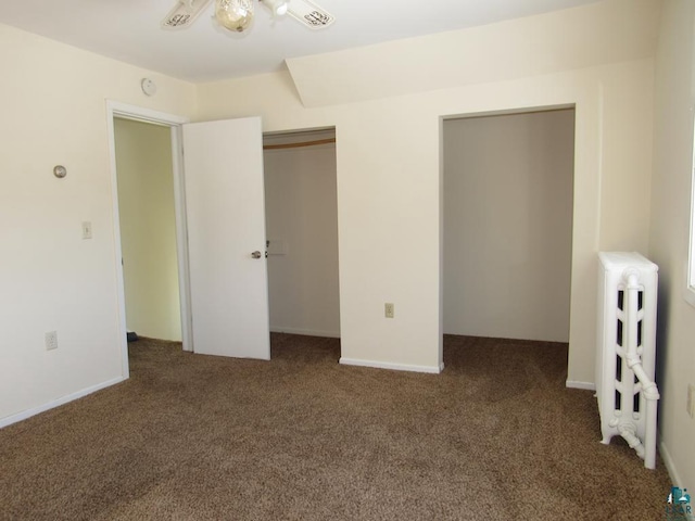 unfurnished bedroom featuring dark carpet