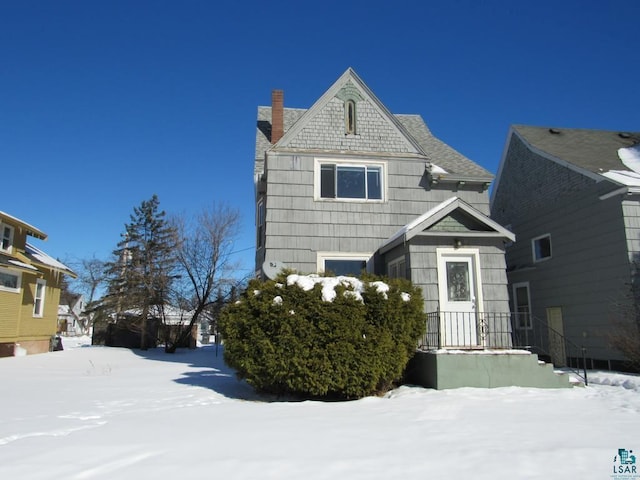 view of front facade featuring a chimney