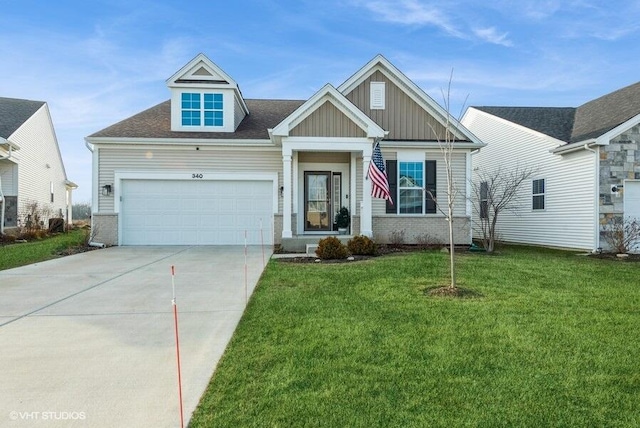 craftsman house with brick siding, an attached garage, board and batten siding, a front yard, and driveway