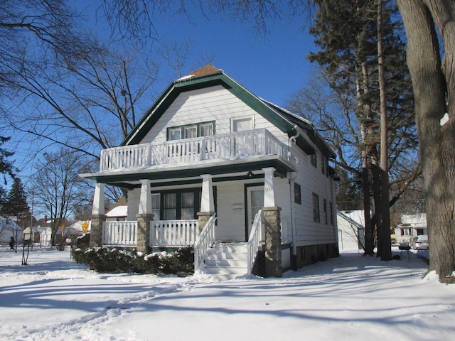 view of front of home with a porch and a balcony