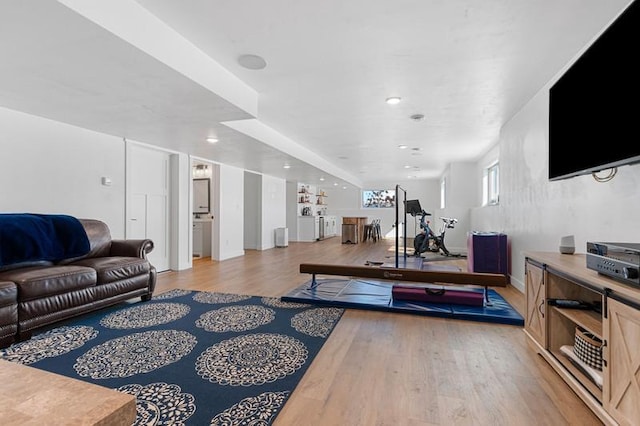 workout room featuring light wood finished floors