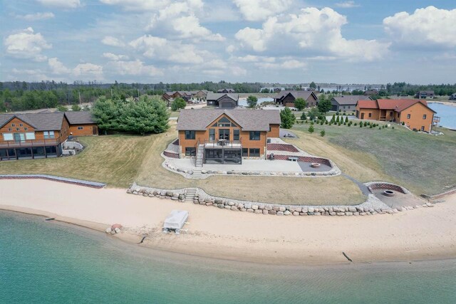 drone / aerial view with a water view and a beach view