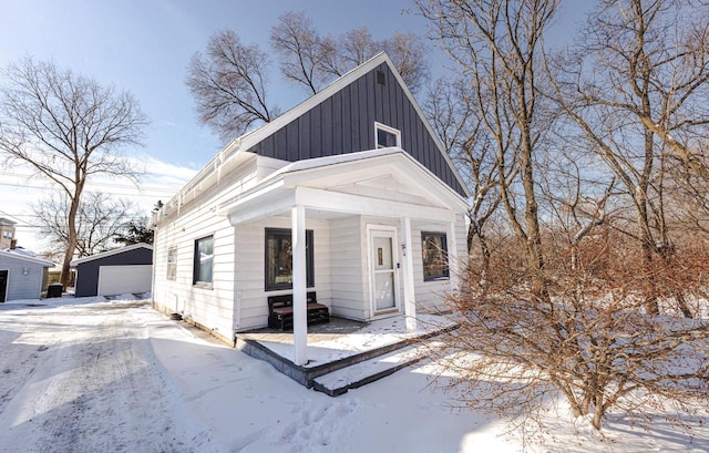 view of front of property with an outbuilding, board and batten siding, and a detached garage