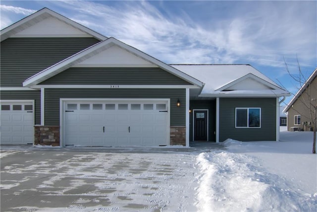 view of front of home with a garage and stone siding