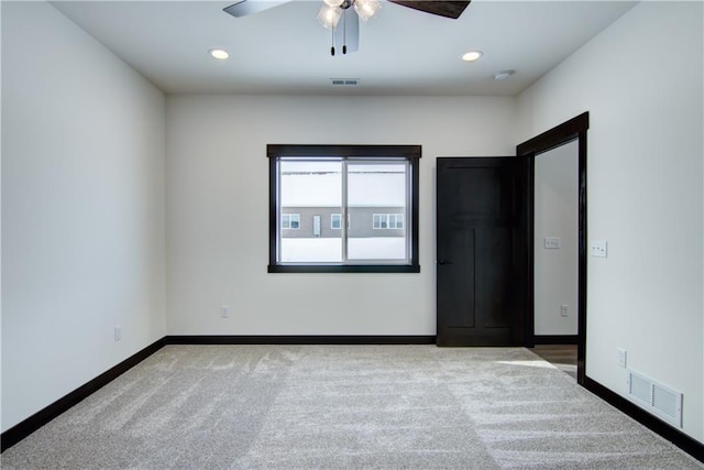 empty room with baseboards, visible vents, carpet flooring, and recessed lighting