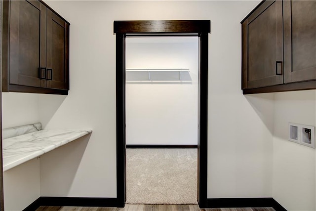 laundry area with hookup for a washing machine and cabinet space