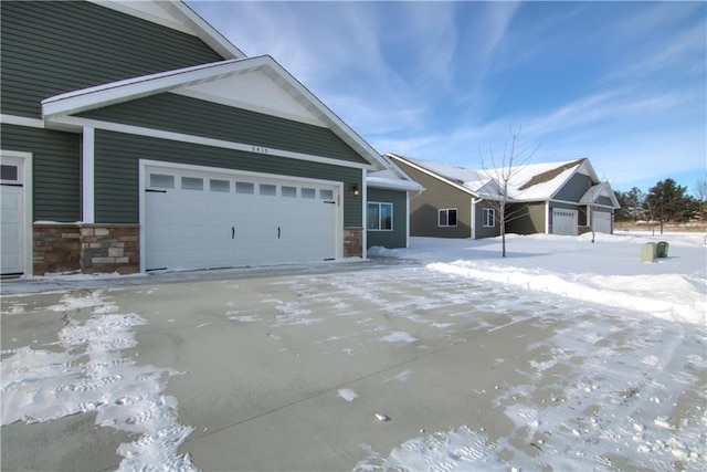 view of front facade with an attached garage and stone siding