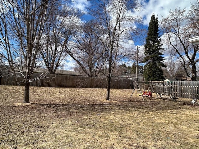 view of yard with a playground and fence