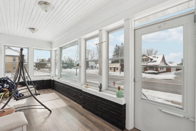 sunroom featuring wood ceiling and plenty of natural light