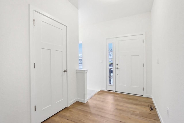 entrance foyer with light wood-type flooring, visible vents, and baseboards