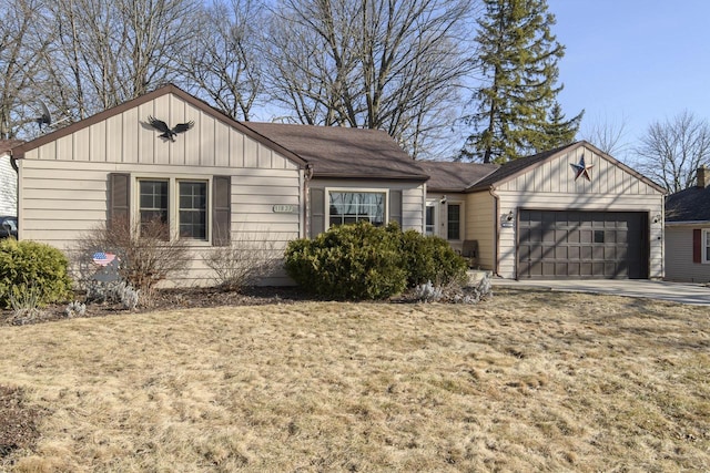 single story home featuring board and batten siding, concrete driveway, and a garage