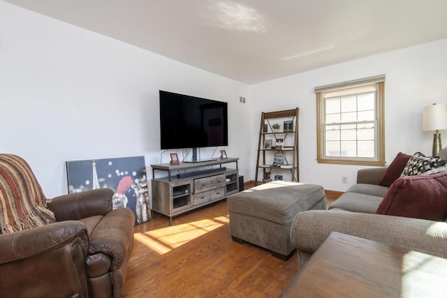 living area with wood finished floors and baseboards