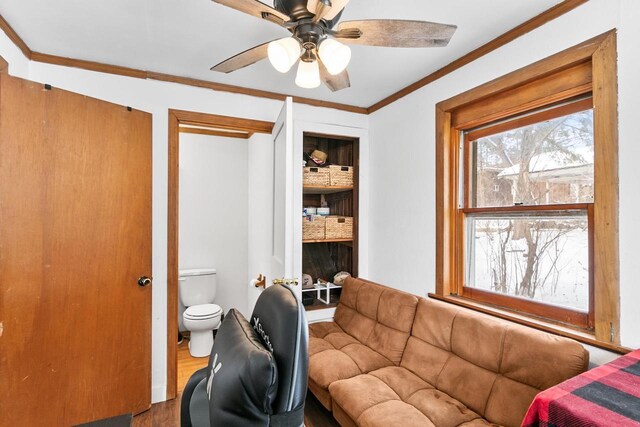 interior space with ornamental molding, ceiling fan, and wood finished floors