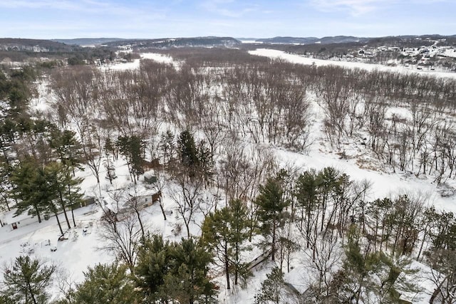 snowy aerial view with a mountain view