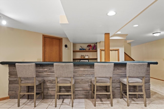 bar featuring recessed lighting, baseboards, and a dry bar