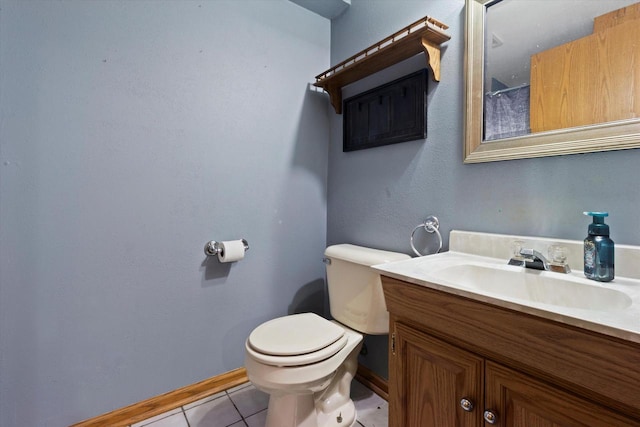 bathroom featuring baseboards, vanity, toilet, and tile patterned floors