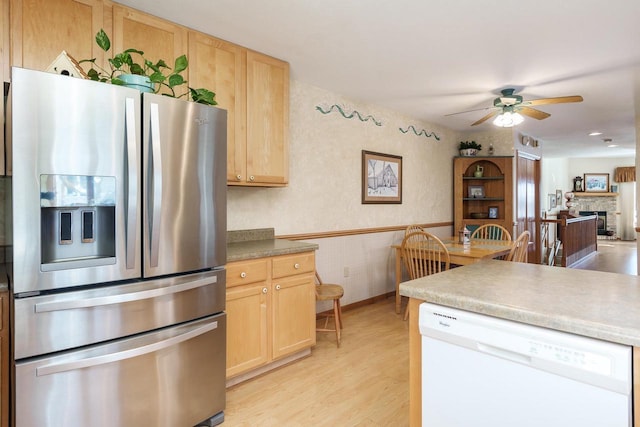 kitchen with white dishwasher, stainless steel refrigerator with ice dispenser, light wood-type flooring, light brown cabinetry, and wallpapered walls