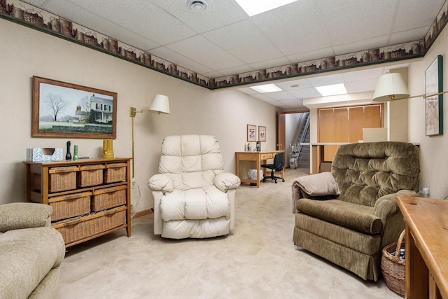 living room featuring a paneled ceiling and light carpet