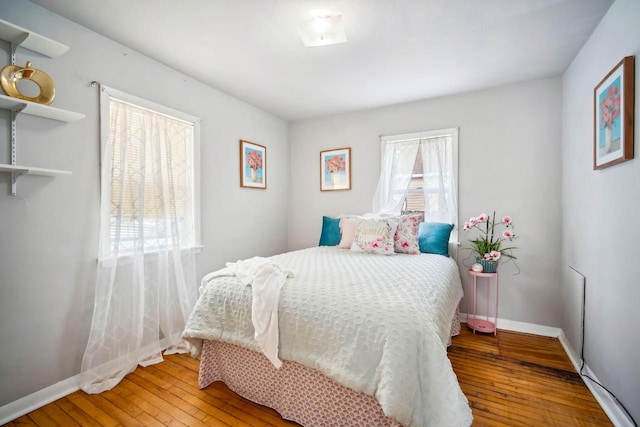 bedroom featuring baseboards and wood finished floors