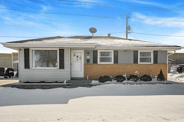 view of front of property with entry steps and brick siding