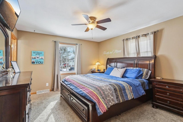 carpeted bedroom with baseboards, visible vents, and ceiling fan