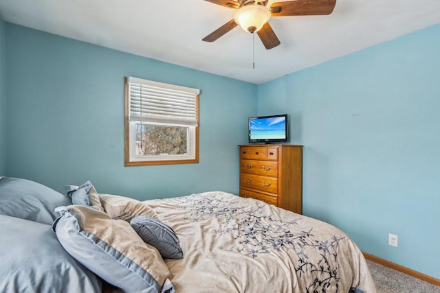 bedroom featuring ceiling fan, baseboards, and carpet