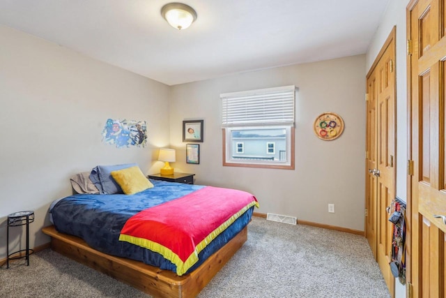 carpeted bedroom with baseboards and visible vents